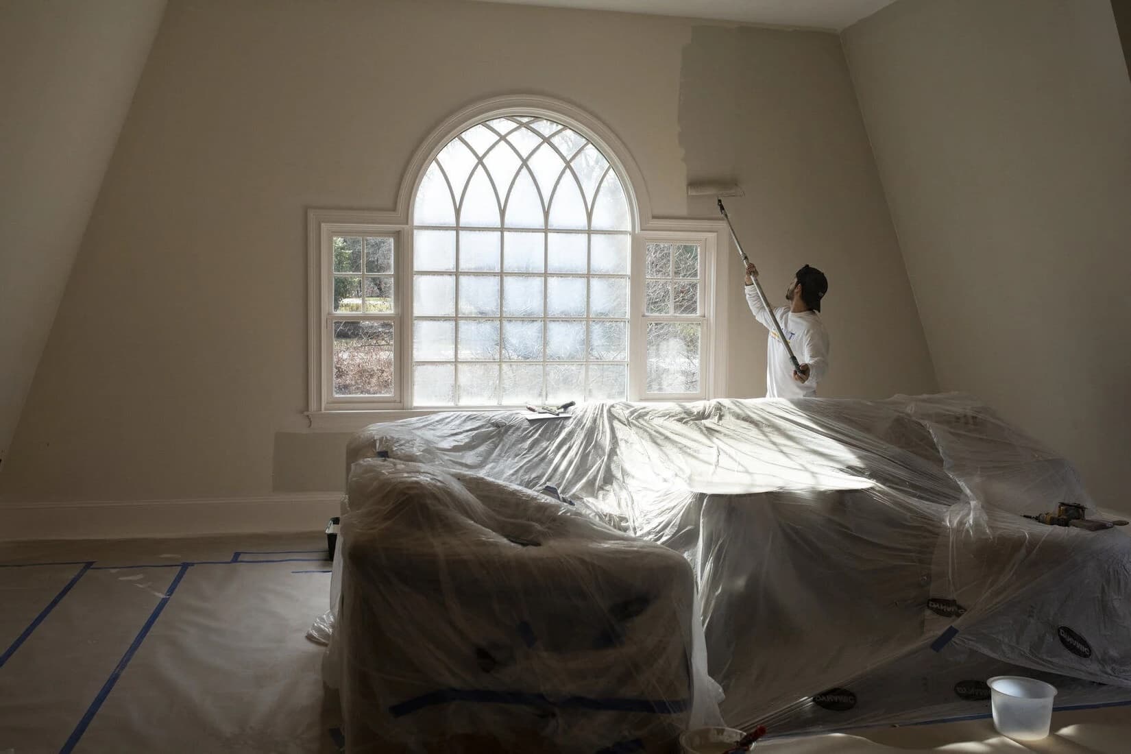 Interior bedroom wall being freshly rolled by a Forest City Painters crew member in London, Ontario